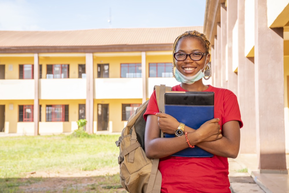 Senior secondary student in uniform outside a senior school